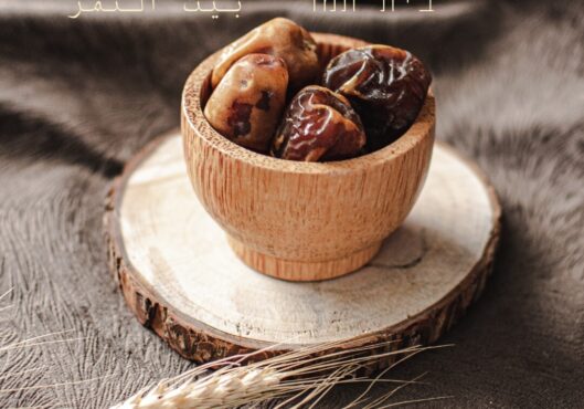 Image of dates in a wooden bowl with wording "Bayt Tamar/Al-Tamr"